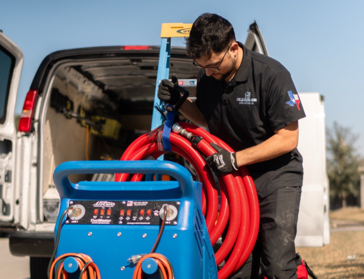 ClearAir technician preparing equipment by service van