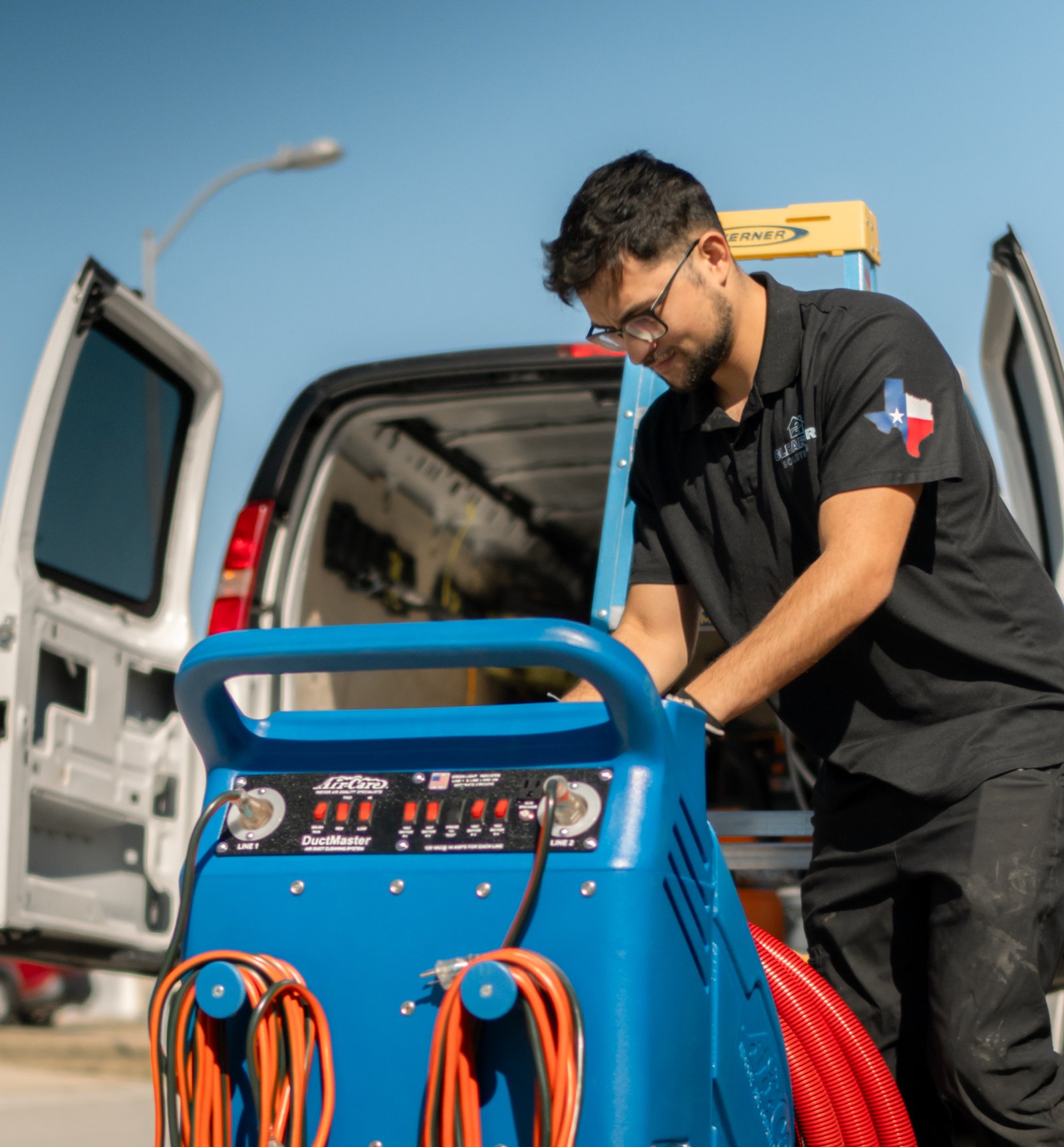 ClearAir Solutions technician with professional DuctMaster equipment at service van in Tomball